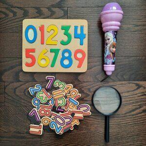 Lot of toys: numbers, microphone, and magnifying glass